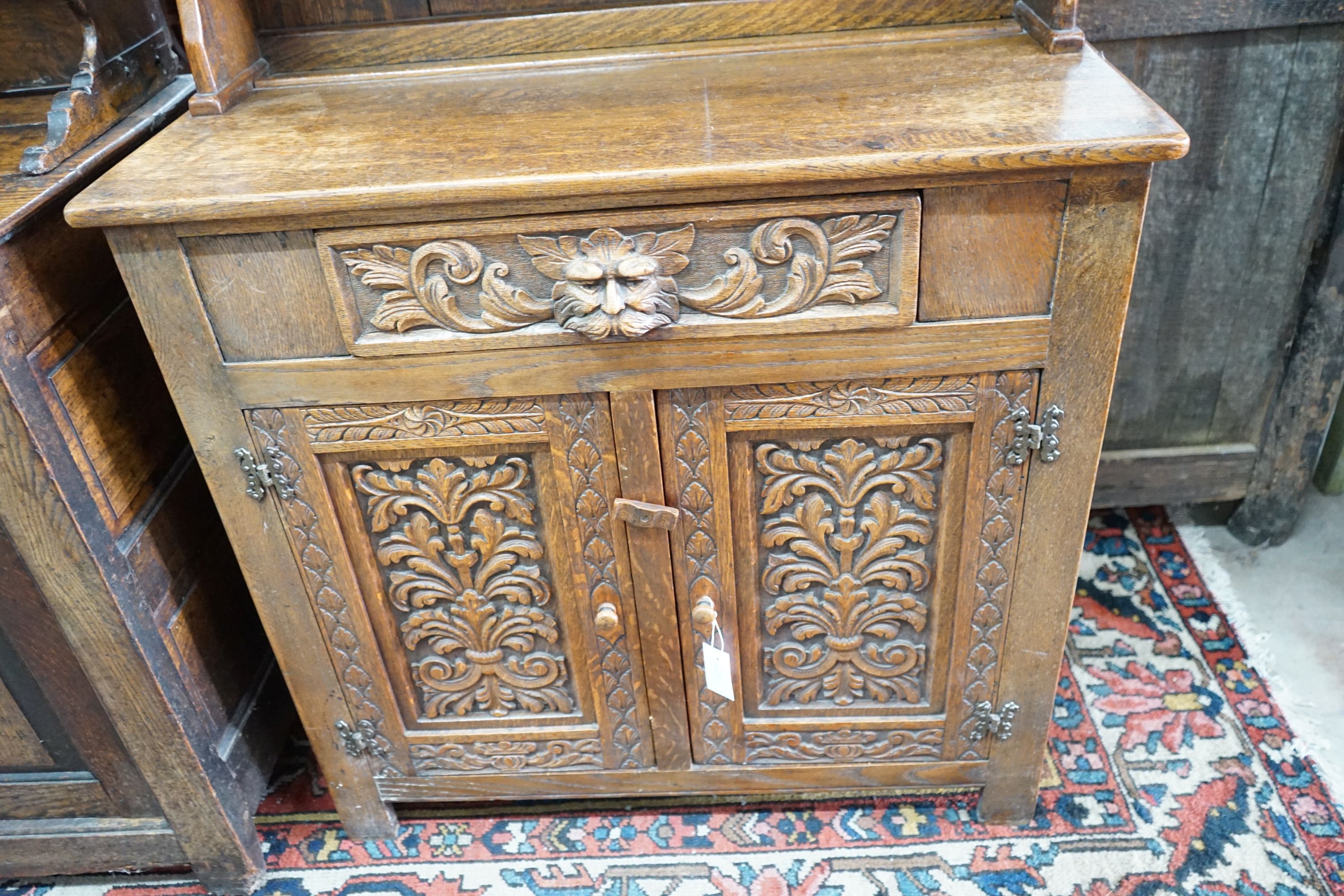 An early 20th century Flemish carved oak dresser, width 91cm, depth 40cm, height 177cm